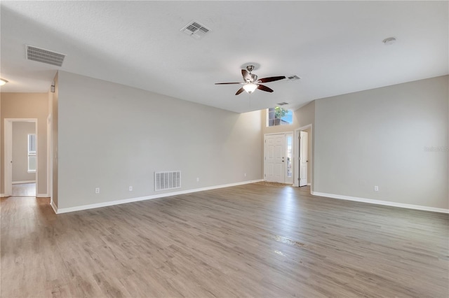 empty room featuring ceiling fan and light hardwood / wood-style floors