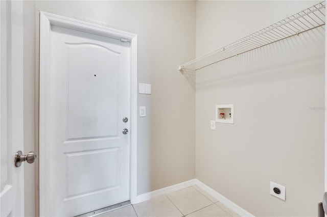 washroom featuring electric dryer hookup, light tile patterned flooring, and washer hookup