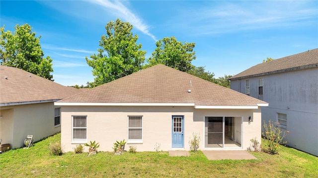 rear view of property featuring a lawn