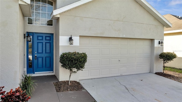 doorway to property with a garage