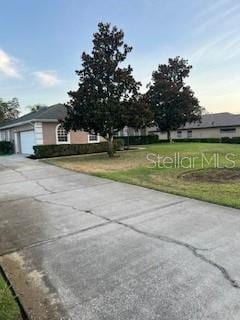 view of front of house with a garage and a front lawn