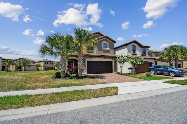 mediterranean / spanish home with a front yard and a garage