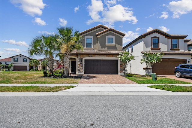 mediterranean / spanish-style home featuring a front yard and a garage