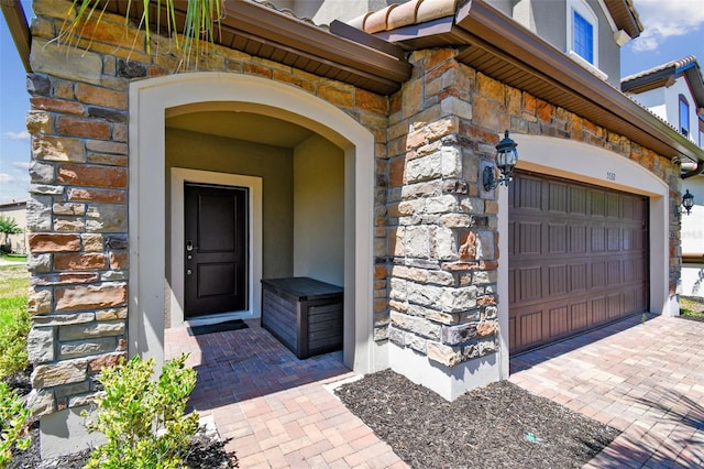 doorway to property featuring a garage