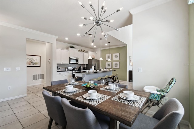 tiled dining space featuring crown molding and an inviting chandelier