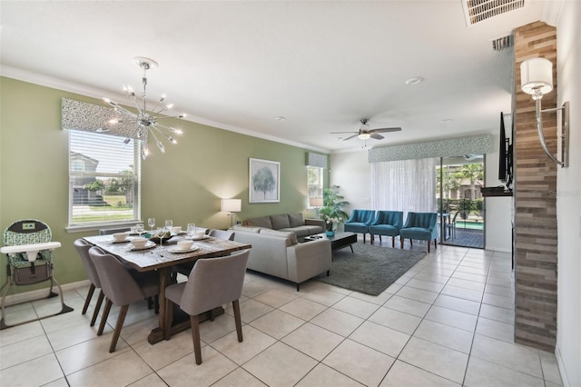 dining room with ceiling fan with notable chandelier, ornamental molding, and light tile patterned floors