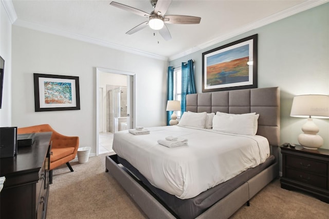 bedroom featuring light carpet, ensuite bathroom, ceiling fan, and ornamental molding