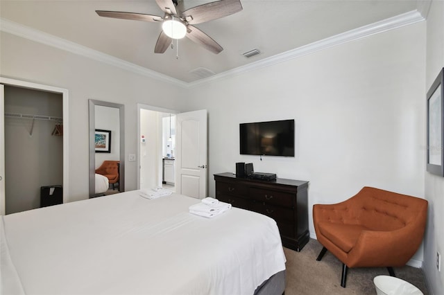 carpeted bedroom with a closet, ceiling fan, and ornamental molding