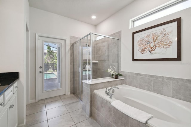 bathroom featuring vanity, tile patterned floors, and separate shower and tub