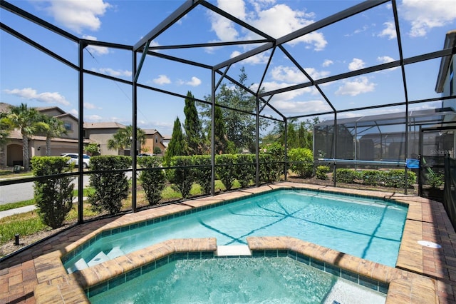 view of pool with an in ground hot tub and a lanai