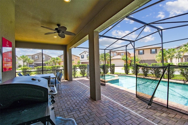 view of swimming pool with grilling area, ceiling fan, a lanai, an in ground hot tub, and a patio