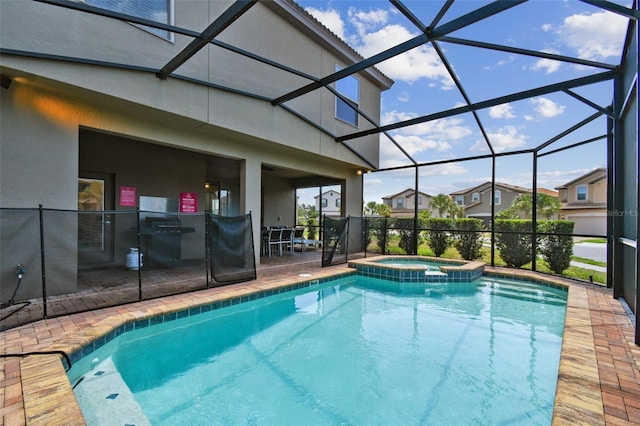 view of pool with a patio area, a lanai, and an in ground hot tub