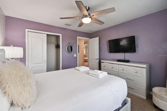 carpeted bedroom with a closet and ceiling fan