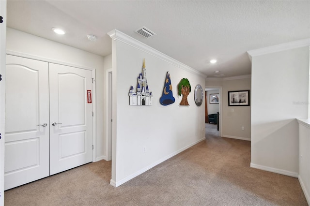 hallway with crown molding and light colored carpet