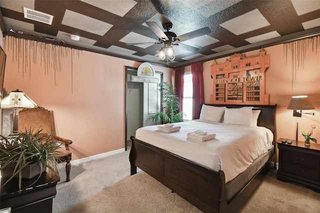 carpeted bedroom with ceiling fan and a textured ceiling