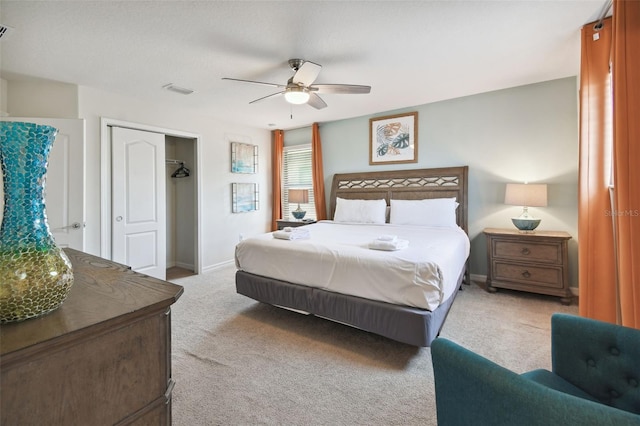 carpeted bedroom with ceiling fan and a closet