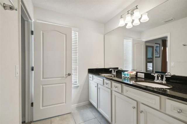 bathroom with tile patterned floors and vanity