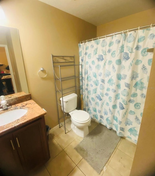 bathroom with a shower with curtain, tile patterned flooring, vanity, and toilet