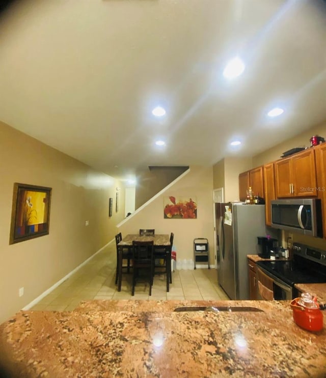 kitchen featuring light tile patterned floors and stainless steel appliances