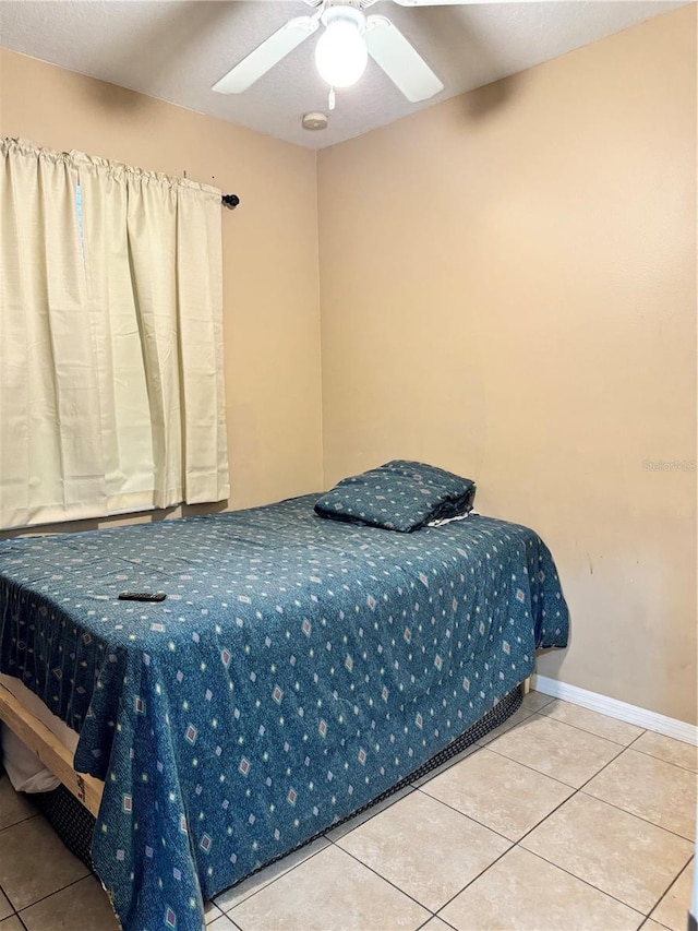 bedroom featuring tile patterned floors and ceiling fan