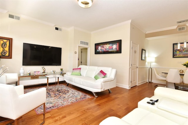 living room featuring crown molding and hardwood / wood-style floors