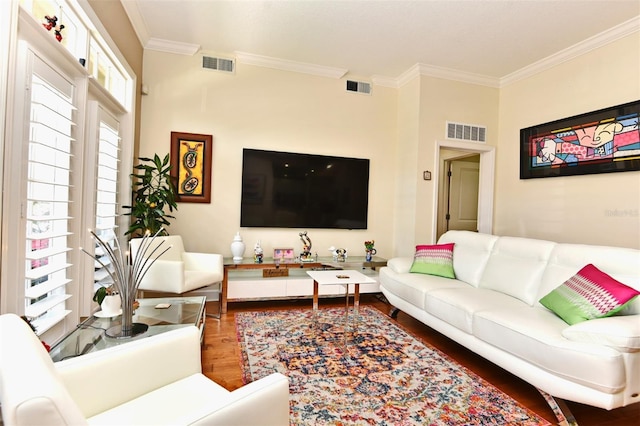 living room featuring hardwood / wood-style flooring and crown molding