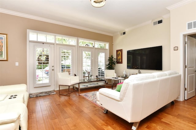 living room with ornamental molding and light wood-type flooring