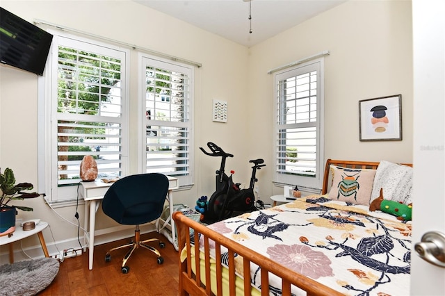 bedroom featuring hardwood / wood-style flooring and multiple windows