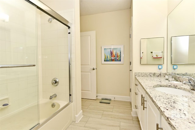 bathroom with vanity and bath / shower combo with glass door