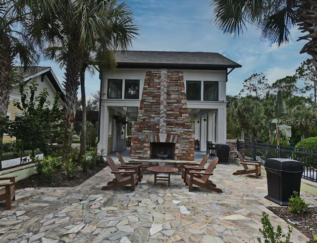 view of patio featuring an outdoor stone fireplace