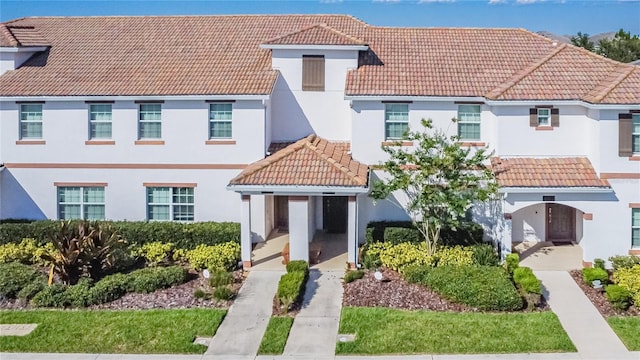 view of front of home with a tiled roof and stucco siding