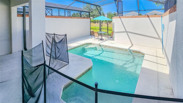 view of pool with a lanai and a patio area