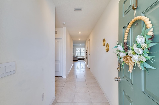 hallway with light tile patterned floors