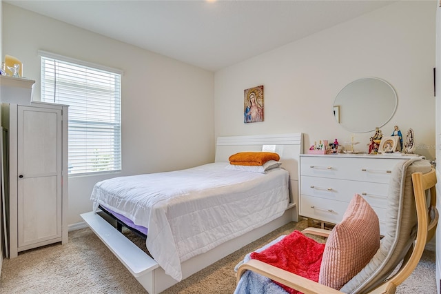 bedroom featuring light colored carpet