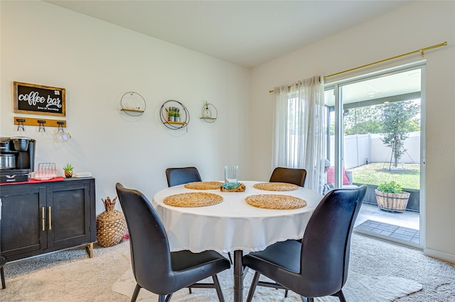 dining room featuring light colored carpet