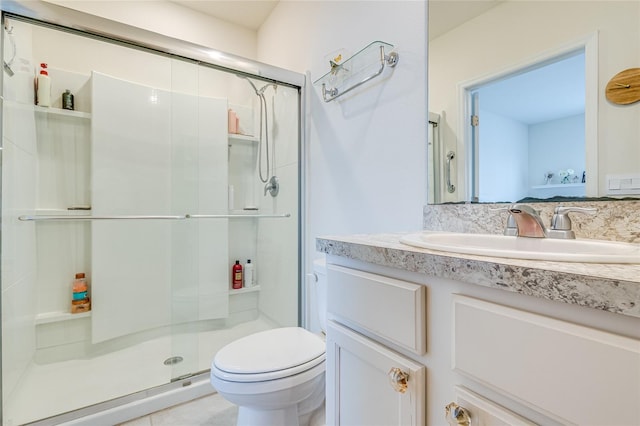 bathroom featuring vanity, toilet, and walk in shower