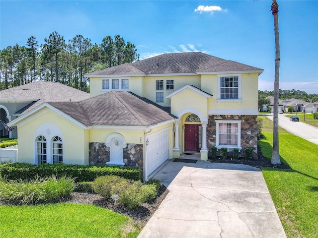 view of front of home with a garage and a front yard