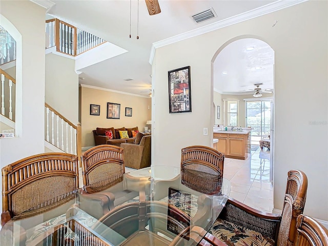 dining room featuring ceiling fan, light tile patterned floors, and ornamental molding