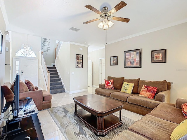 tiled living room featuring ceiling fan with notable chandelier