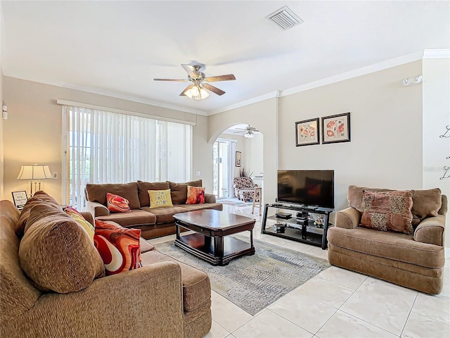 living room featuring light tile patterned flooring, crown molding, and ceiling fan