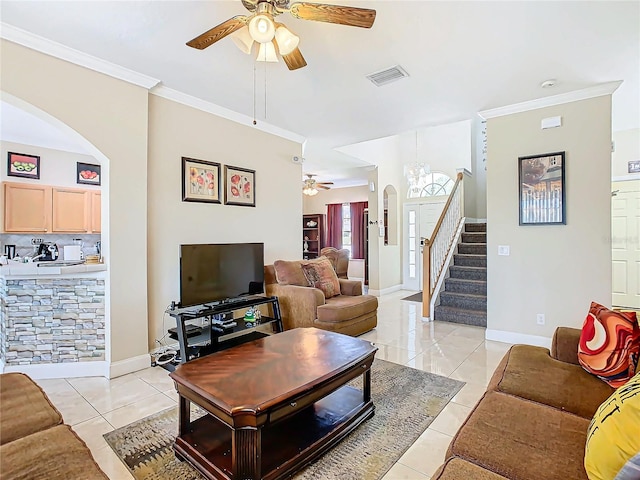 tiled living room with crown molding and ceiling fan