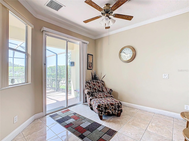 living area with ornamental molding, ceiling fan, and light tile patterned flooring