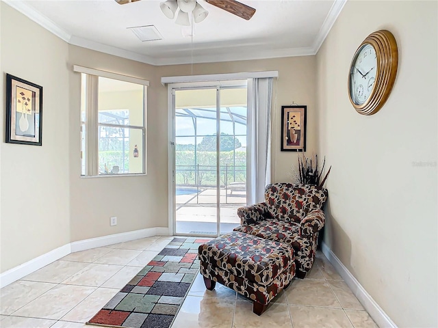 living area featuring ornamental molding, ceiling fan, and light tile patterned floors