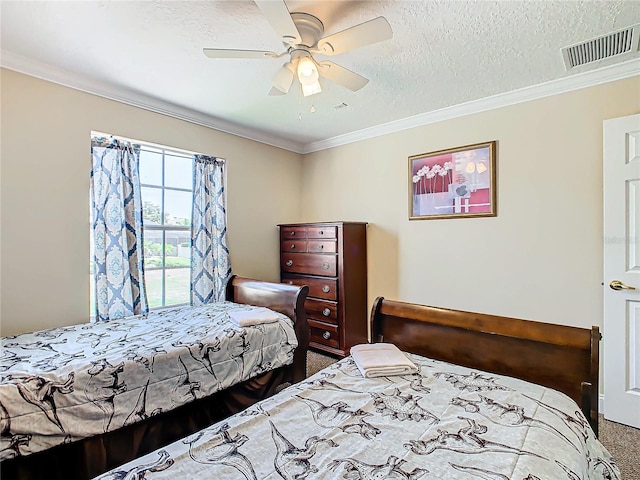 bedroom featuring ornamental molding, ceiling fan, a textured ceiling, and carpet flooring