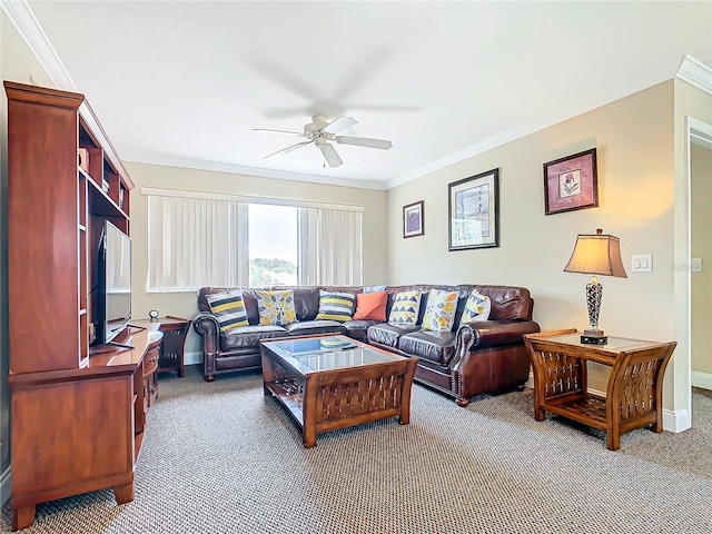 carpeted living room with ornamental molding and ceiling fan