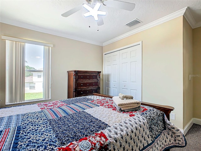 bedroom featuring a closet, crown molding, a textured ceiling, and ceiling fan