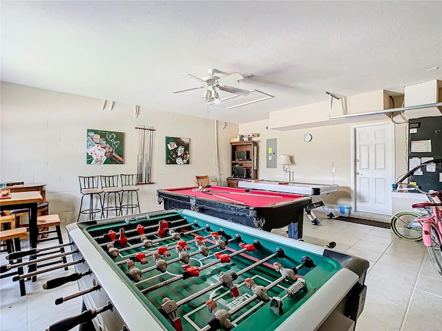 recreation room featuring ceiling fan, billiards, electric panel, light tile patterned floors, and a textured ceiling