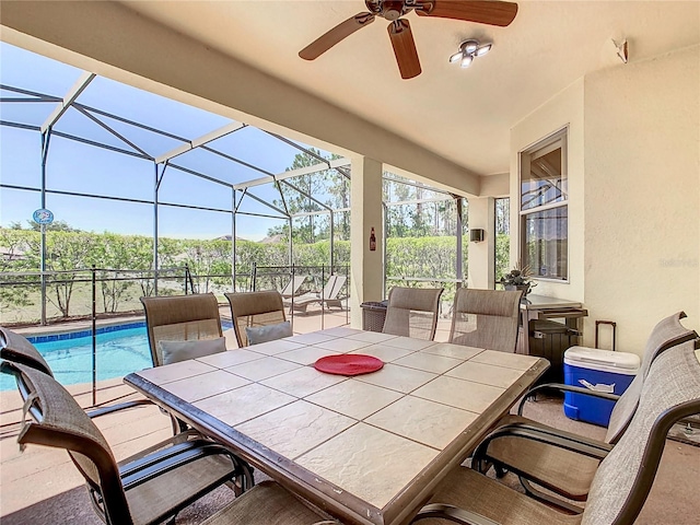 view of patio / terrace with ceiling fan and a lanai