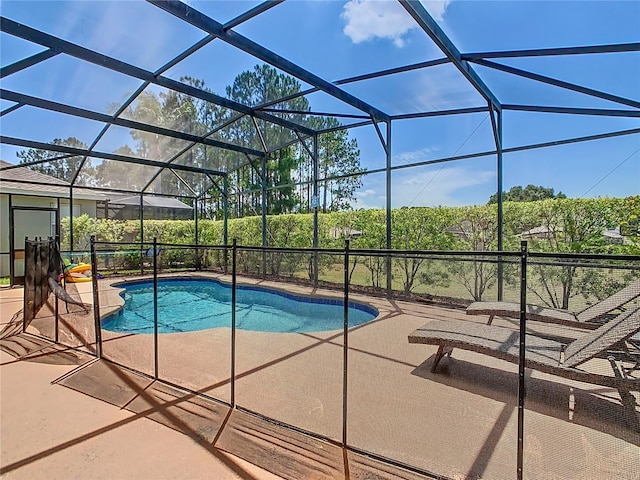 view of pool featuring a patio and glass enclosure