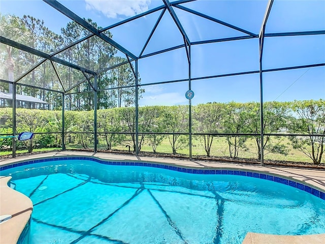 view of pool featuring glass enclosure